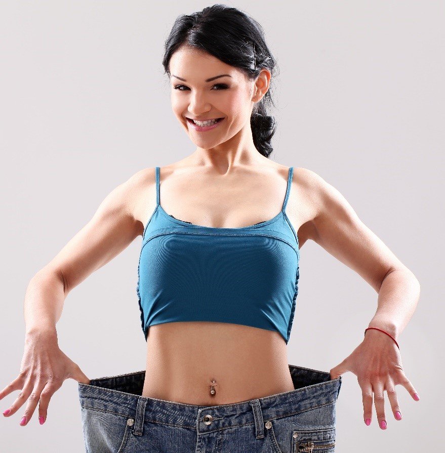 A women happily showing her weight loss